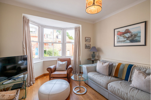 Comfortable holiday home sitting room with a bay window