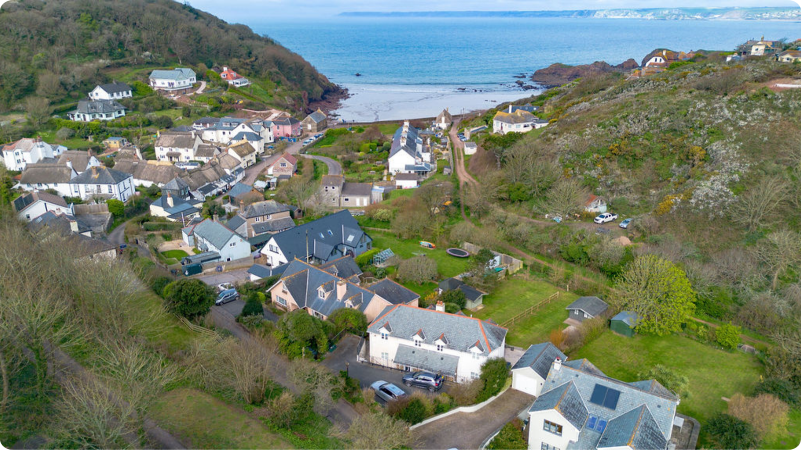Aerial view across Hope Cove village towards the beach