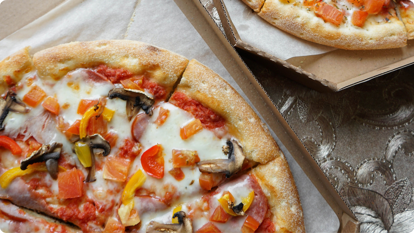 Freshly prepared takeaway pizzas in open boxes