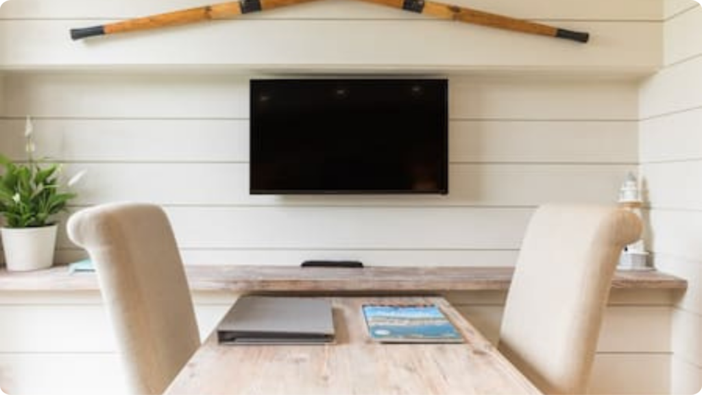 Guest information and television in a bright holiday cottage living area